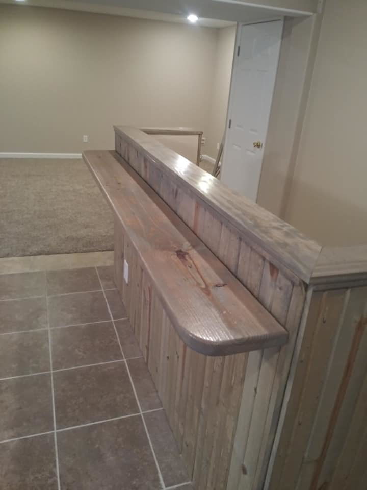 A custom wooden bar constructed as part of a basement remodel by Cali Painting in Fort Collins, CO