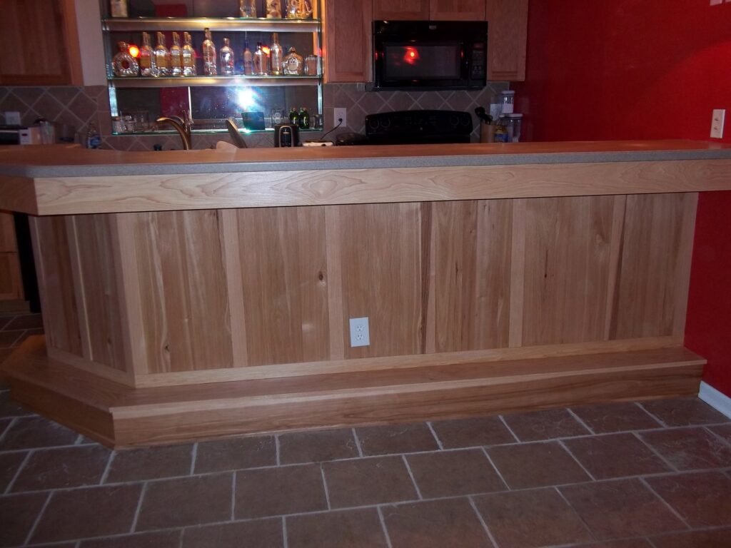 A custom-built wooden bar with a tiled floor, expertly installed by Handyman Joe in Omaha, NE