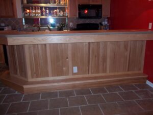 A custom-built wooden bar with a tiled floor, expertly installed by Handyman Joe in Omaha, NE