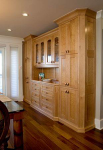 Custom wooden built-in cabinetry with glass doors and drawers installed by ArcherRead Woodworking in Wilmington, NC