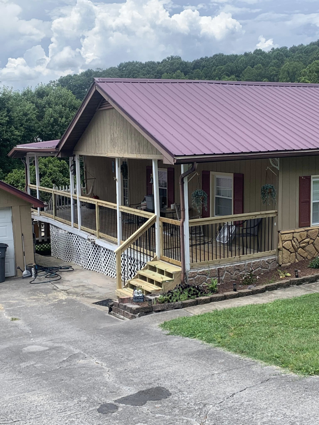 A custom-built wooden deck and stairs completed by Dream Construction in Johnson City, TN.