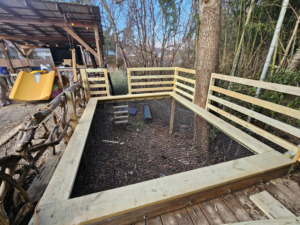 A custom-built wooden enclosure with fencing installed by Carter Remodeling in Cartersburg, IN.