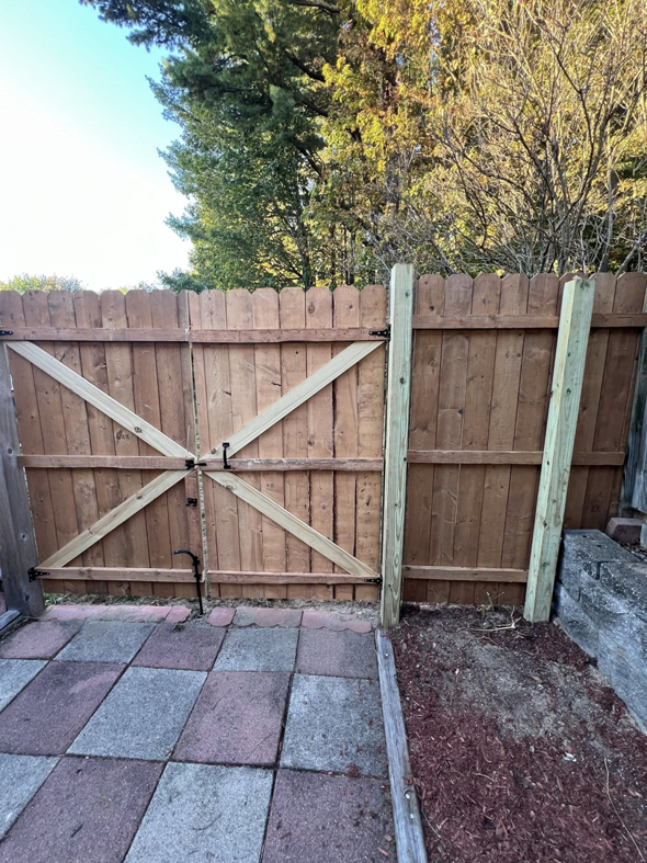A custom wooden fence gate with diagonal bracing installed by Fence Masters NH in Concord, NH.