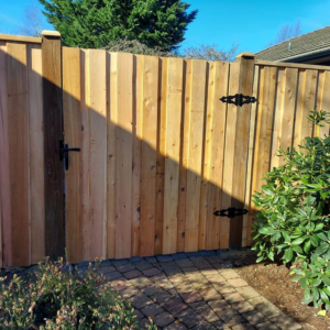 Custom wooden fence gate installation by Terrazas yard maintenance & construction LLC in Eugene, OR.