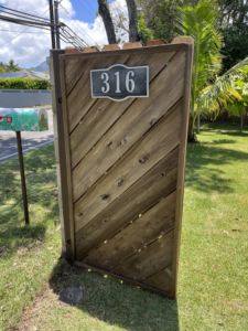 Custom wooden gate installation with house number 316 by Trusted Handyman, providing property enhancements in Honolulu, HI.