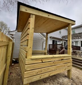 Custom-built wooden outdoor structure with a sloped roof by BOS HOME Exterior Services in Virginia Beach, VA