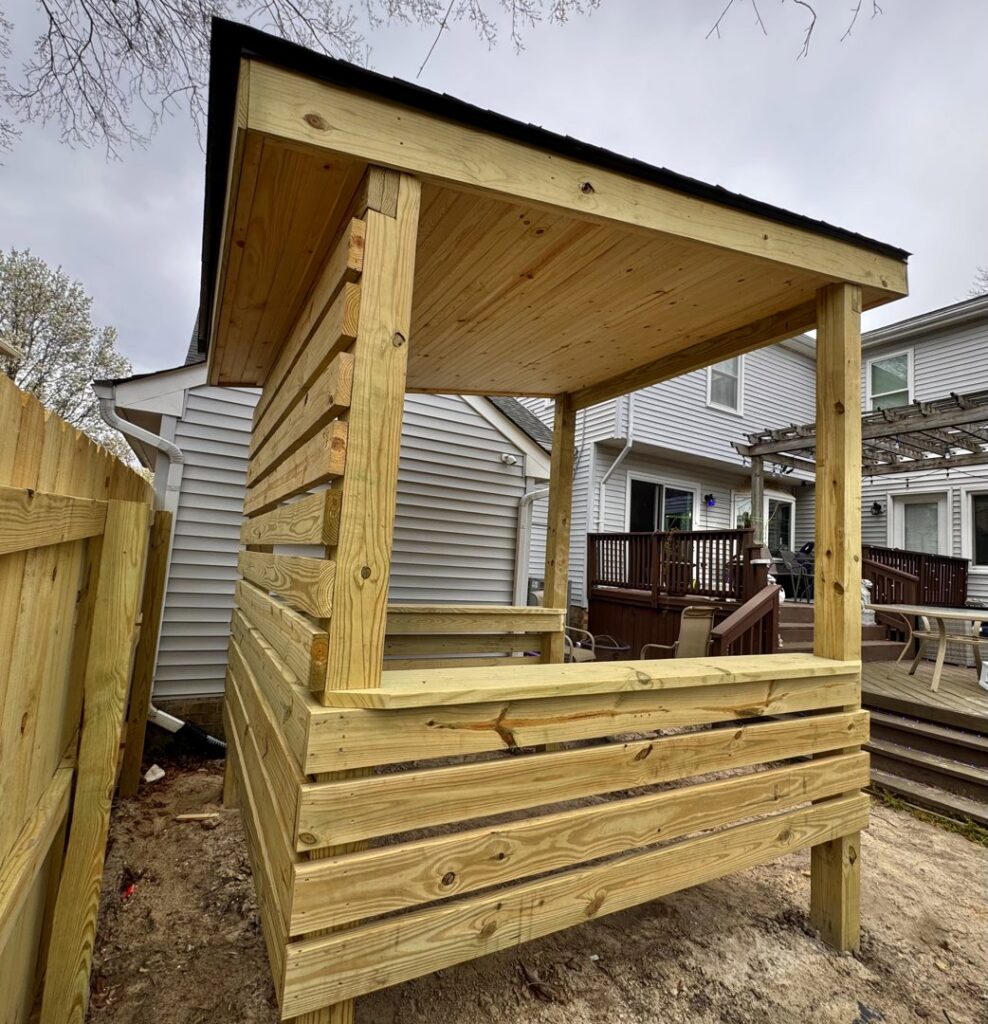 Custom-built wooden outdoor structure with a sloped roof by BOS HOME Exterior Services in Virginia Beach, VA