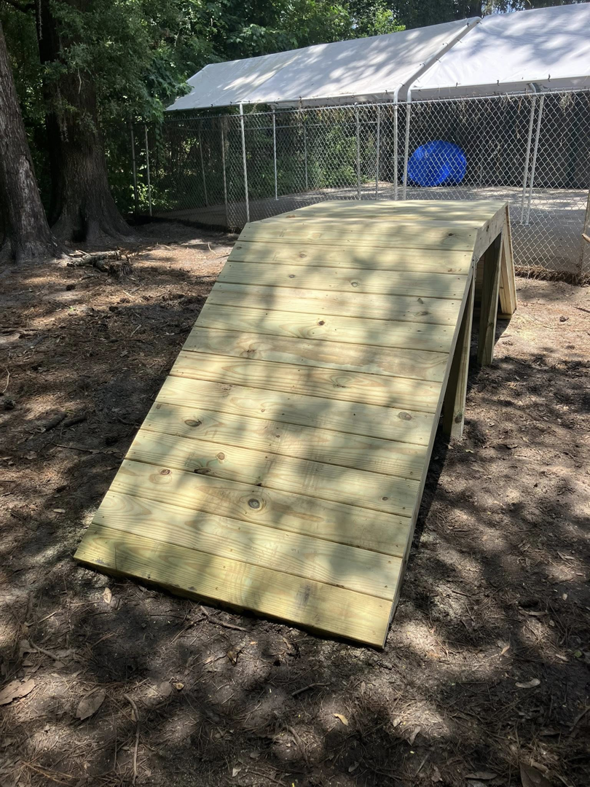 A custom-built wooden ramp in an outdoor setting, constructed by Jack Of All Enterprises in Savannah, GA.