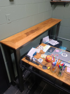 A custom-built wooden shelf installed above a desk, showcasing carpentry by The Cowboy Carpenter Handyman Service LLC in Bismarck, ND.