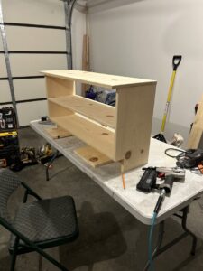 A custom wooden shelf unit under construction with tools, a service by Rockin & Rollin Handyman Services in North Ogden, UT.