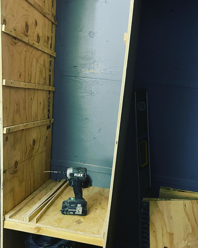 A drill on custom wooden shelving being installed by Un1que.homes for home organization in Idaho Falls, ID.