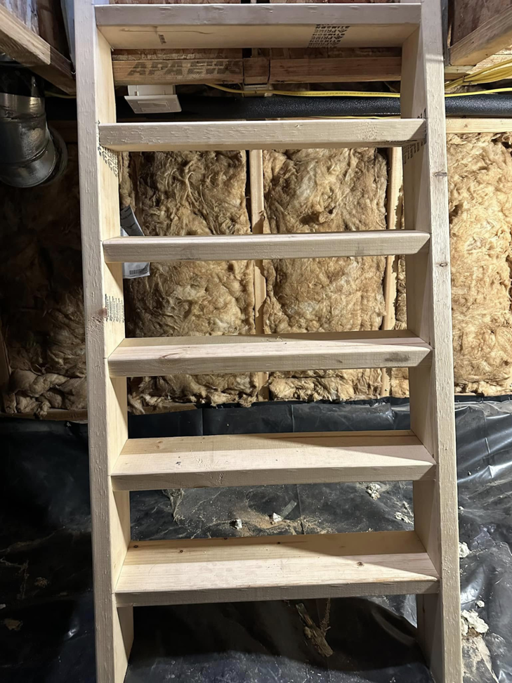 Custom wooden stairs under construction in a basement by Blue Heron Property Care LLC in Kalispell, MT