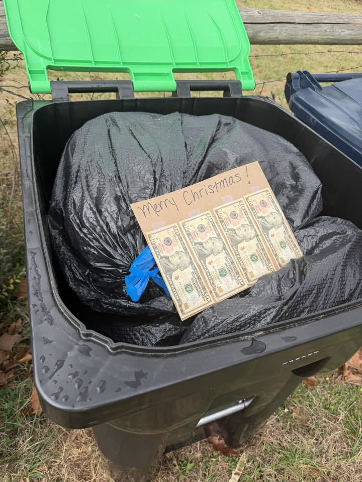 An open trash bin with a customer's tip and a 'Merry Christmas!' note for Elevate Disposal Services, LLC in Bentonville, AR