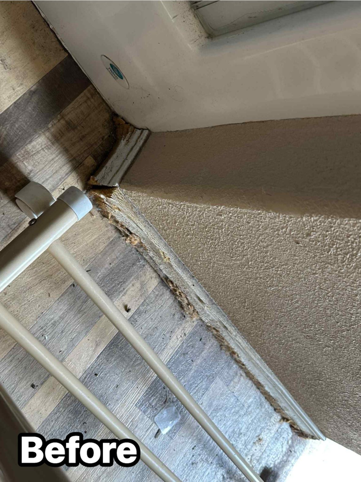 Damaged baseboards and wall before repair, showing the 'Before' state for a handyman service by KDB Roofing & Construction in Tulsa, OK