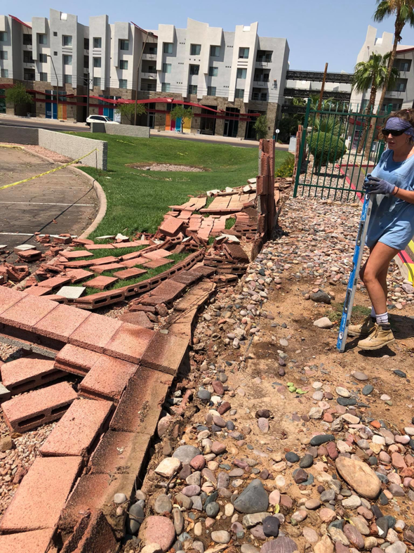 A damaged brick wall undergoing demolition or repair work by Ken's Masonry, LLC in Chandler, AZ.