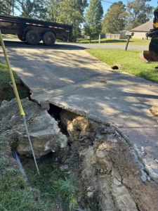 A severely damaged concrete driveway requiring repair or replacement by Louisiana Land Solutions in West Monroe, LA.