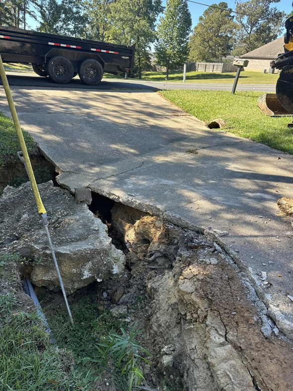 A severely damaged concrete driveway requiring repair or replacement by Louisiana Land Solutions in West Monroe, LA.
