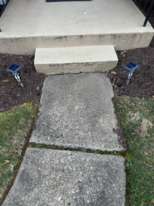 A damaged and cracked concrete walkway before repair by DG Maintenance Services LLC in Wilmington, DE