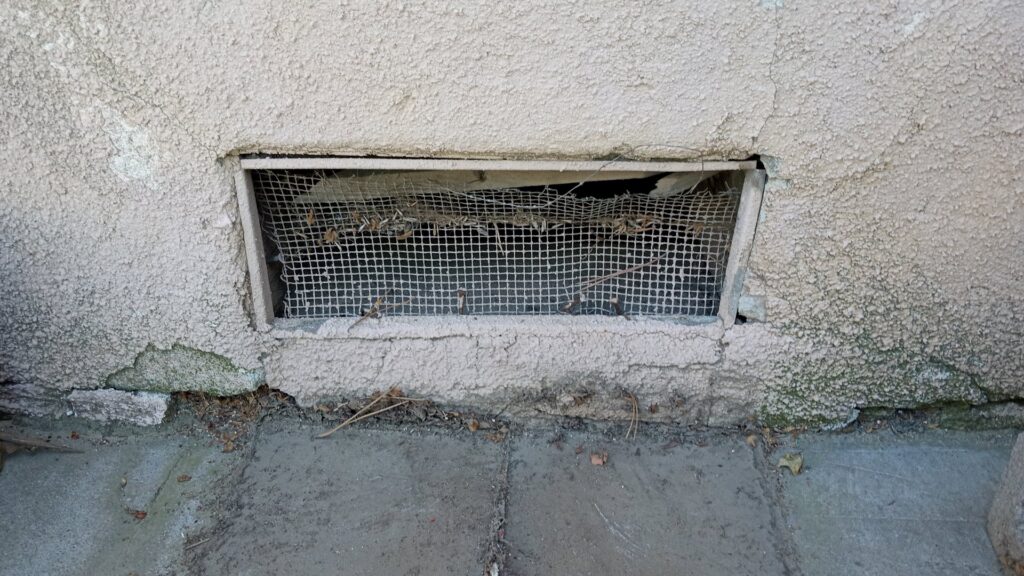 Damaged crawl space vent needing repair by Cal Heights Construction And Handyman Services in Bakersfield, CA
