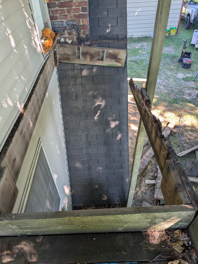 A top-down view of a damaged deck during demolition or repair by Handyman Service in Lafayette, IN.