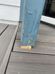 A close-up of a damaged and weathered deck post needing repair, a service by Handyman Connection of Fort Collins in Fort Collins, CO