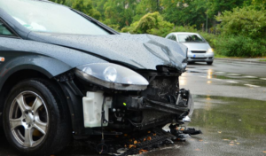 A severely damaged grey car after a front-end collision, ready for removal by Don's Automotive Removal in Thomasville, NC.