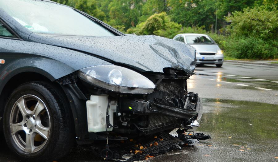 A severely damaged grey car after a front-end collision, ready for removal by Don's Automotive Removal in Thomasville, NC.