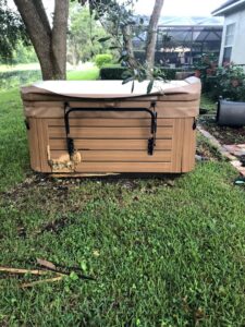 A damaged hot tub in a residential backyard, ready for removal by Pro Dumpsters & Junk Removal in Orlando, FL.