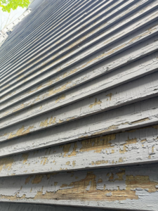 Damaged house siding with extensive peeling paint, a common repair for Isac's General Services LLC in Henrico, VA