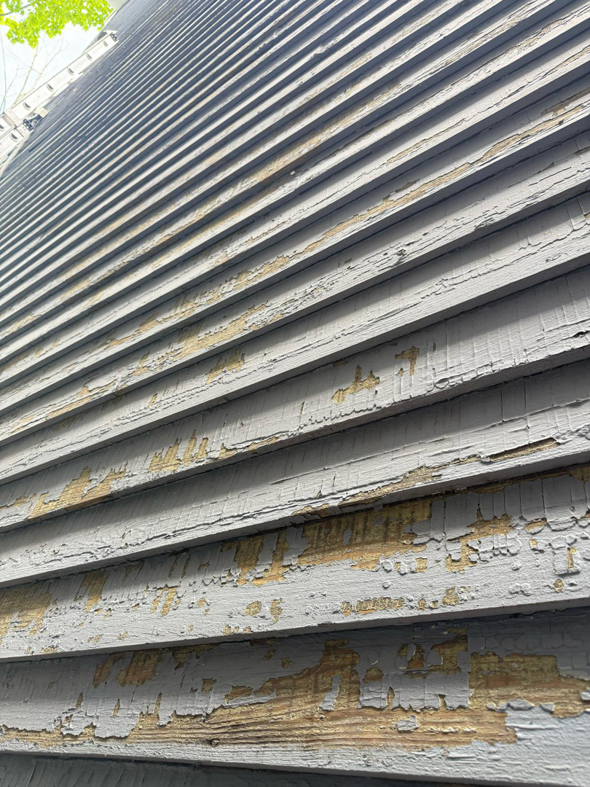Damaged house siding with extensive peeling paint, a common repair for Isac's General Services LLC in Henrico, VA