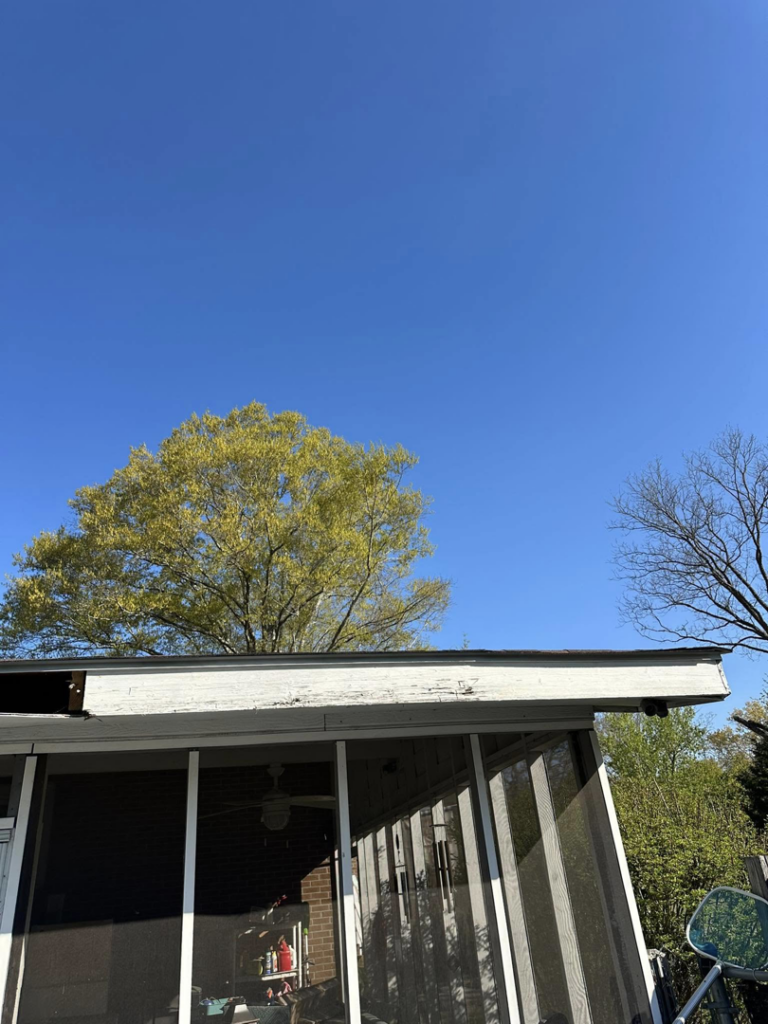 Damaged roof fascia and soffit on a screened porch, indicating a handyman repair project by Fence&Wash in Rock Hill, SC.