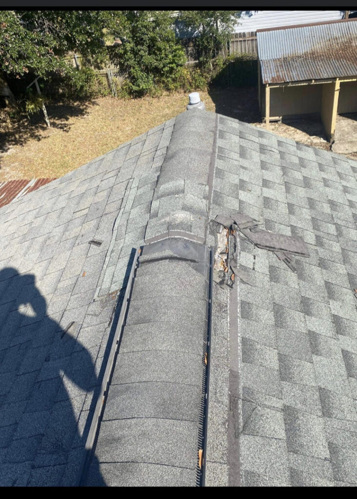 A damaged roof with missing shingles, indicating a need for repair or inspection by SMM Services LLC in Gulfport, MS.