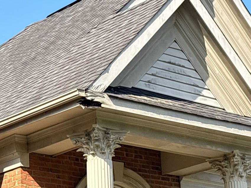 Close-up of damaged roof shingles and fascia requiring repair by A&M Roofing in Springfield, VA.