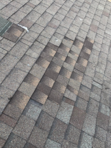A shingled roof with visible damage and missing shingles, ready for repair by Dan's "Do it All" Handyman Services in Reno, NV.