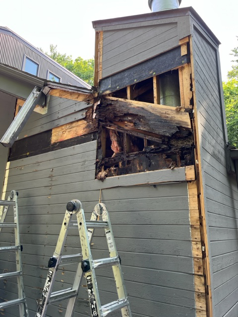 Damaged siding and exposed wood being repaired on a house exterior by Cedar Siding Repair in Centerville, OH.