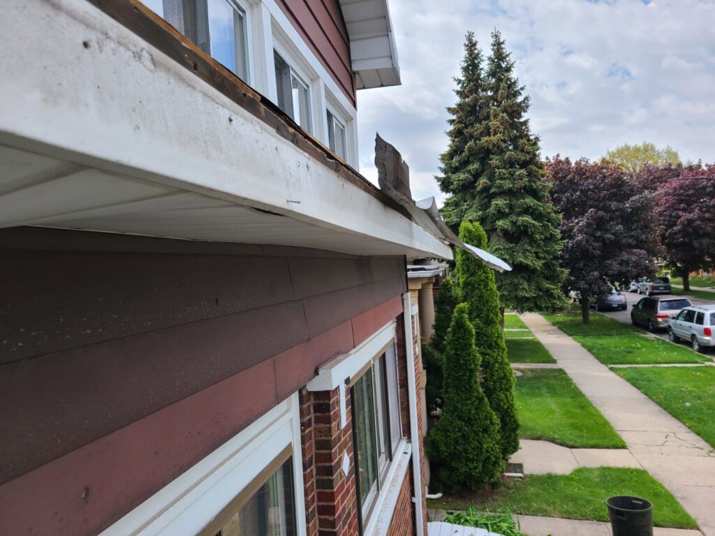Damaged siding and gutter on a residential house, indicating a need for repair by Pro DK Contractor LLC in Chicago, IL.