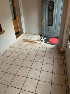 Damaged tile flooring in an entryway before renovation by Tawfiq Services LLC in Philadelphia, PA