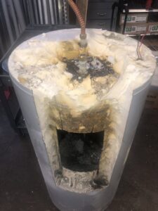 Damaged water heater showing internal corrosion, a plumbing service by Epic Electric, Heating, Cooling & Plumbing in Spokane, WA