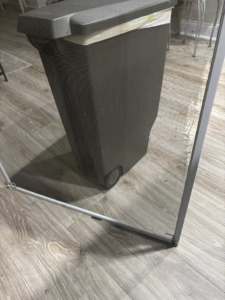 A damaged window screen with tears in the mesh, indicating a need for repair by JJConstruction203 LLC in Charlotte, NC.