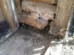 Close-up of damaged wood and foundation requiring repair by Anderson Builders, LLC in Twin Falls, ID