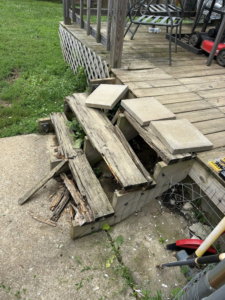 Severely damaged and broken wooden deck stairs needing repair or replacement by A2 Construction in Louisville, KY.