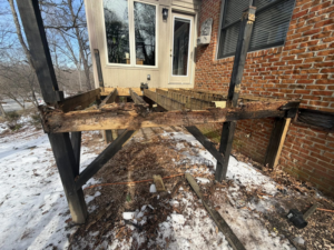 A damaged wooden deck structure requiring repair or demolition services from IWork Home Services in Greensboro, NC.