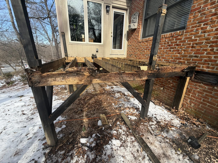 A damaged wooden deck structure requiring repair or demolition services from IWork Home Services in Greensboro, NC.