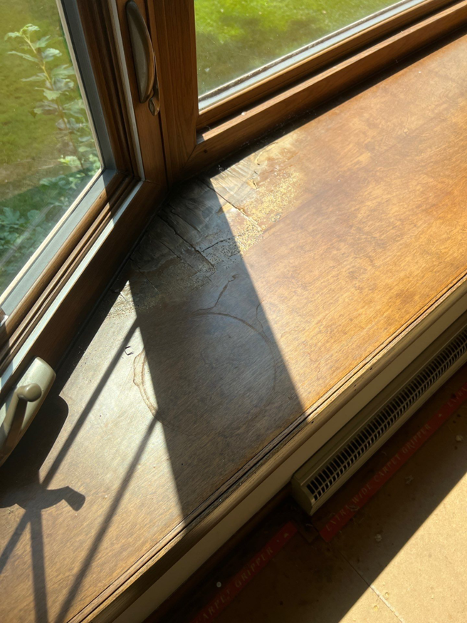 A damaged wooden window sill in need of repair by Thebco Windows, Doors & Siding in Madison, WI.