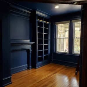 Dark blue custom built-in bookshelves and wall paneling by Corkery Customs & Remodeling LLC in Philadelphia, PA