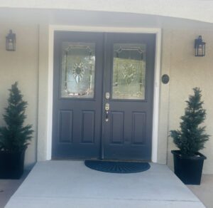 Newly installed dark blue double front doors with decorative glass by Greg Unseth Painting & Exteriors in Colorado Springs, CO