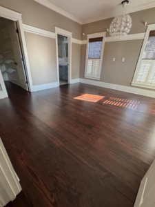 Beautifully refinished dark hardwood floor in a room by Trades by Taylor LLC in Huntsville, AL.