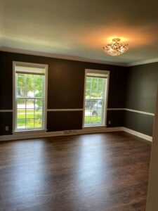 A room with elegant dark hardwood flooring and matching dark walls, expertly installed by Nelson Hardwood Flooring in Madison, WI.