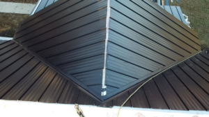 A close-up aerial view of a dark metal roof installation with visible seams by SJL Contracting, LLC in Owensboro, KY.