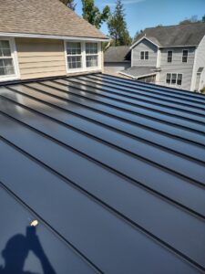 Close-up view of a dark standing seam metal roof installed by JB Home Improvement Services in Sanford, FL.